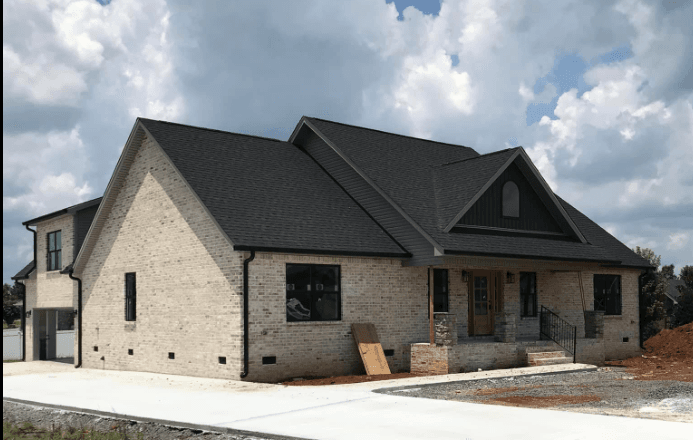 Home with Ironstone siding and black gutters