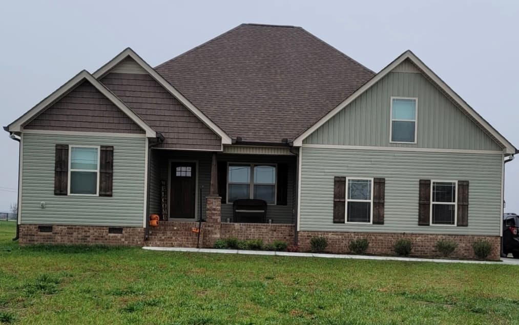 Home with vinyl siding, shake, and Board and Batten