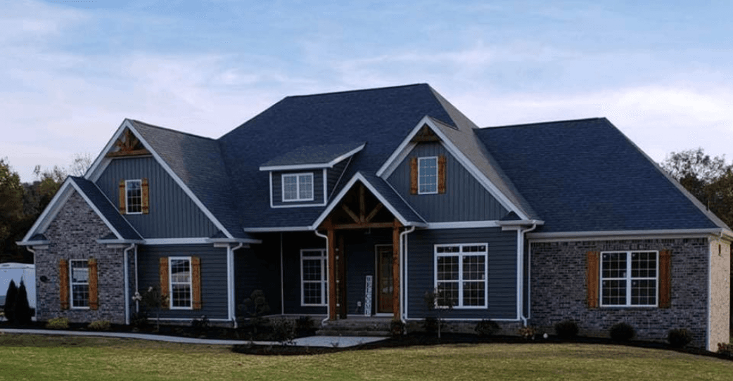 Home with blue vinyl siding and Board and Batten accents